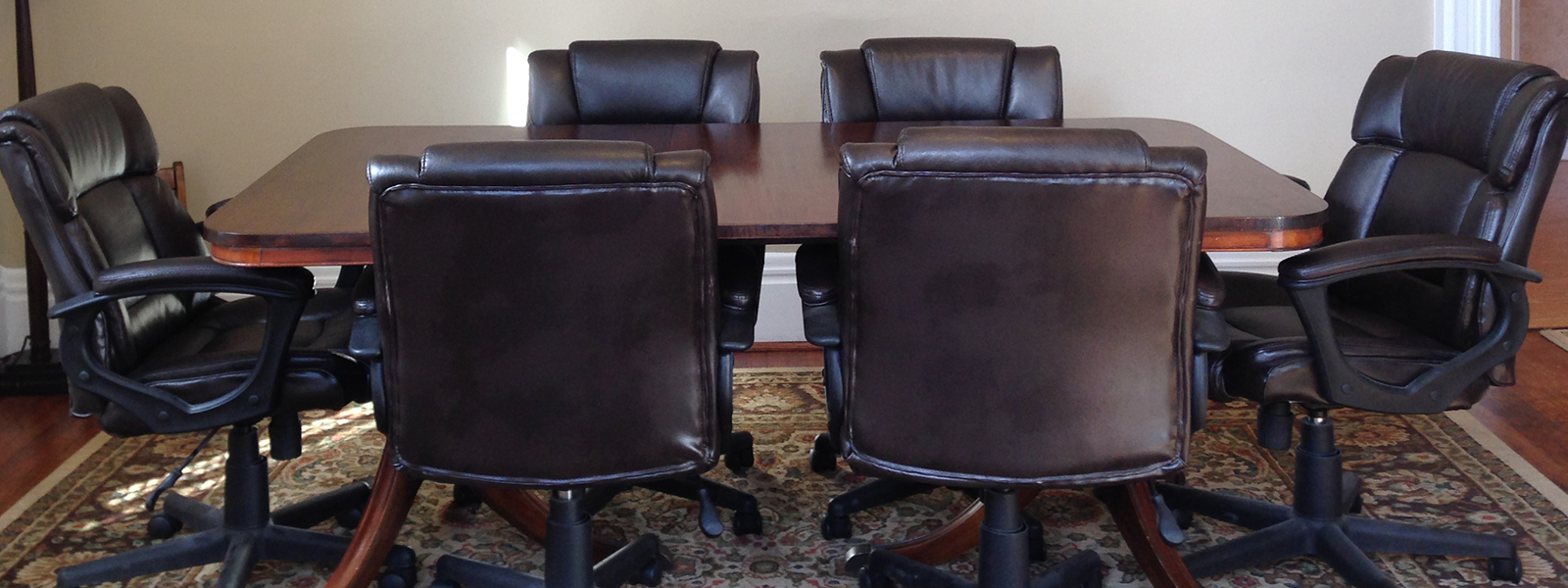 a conference room with a table surrounded by chairs